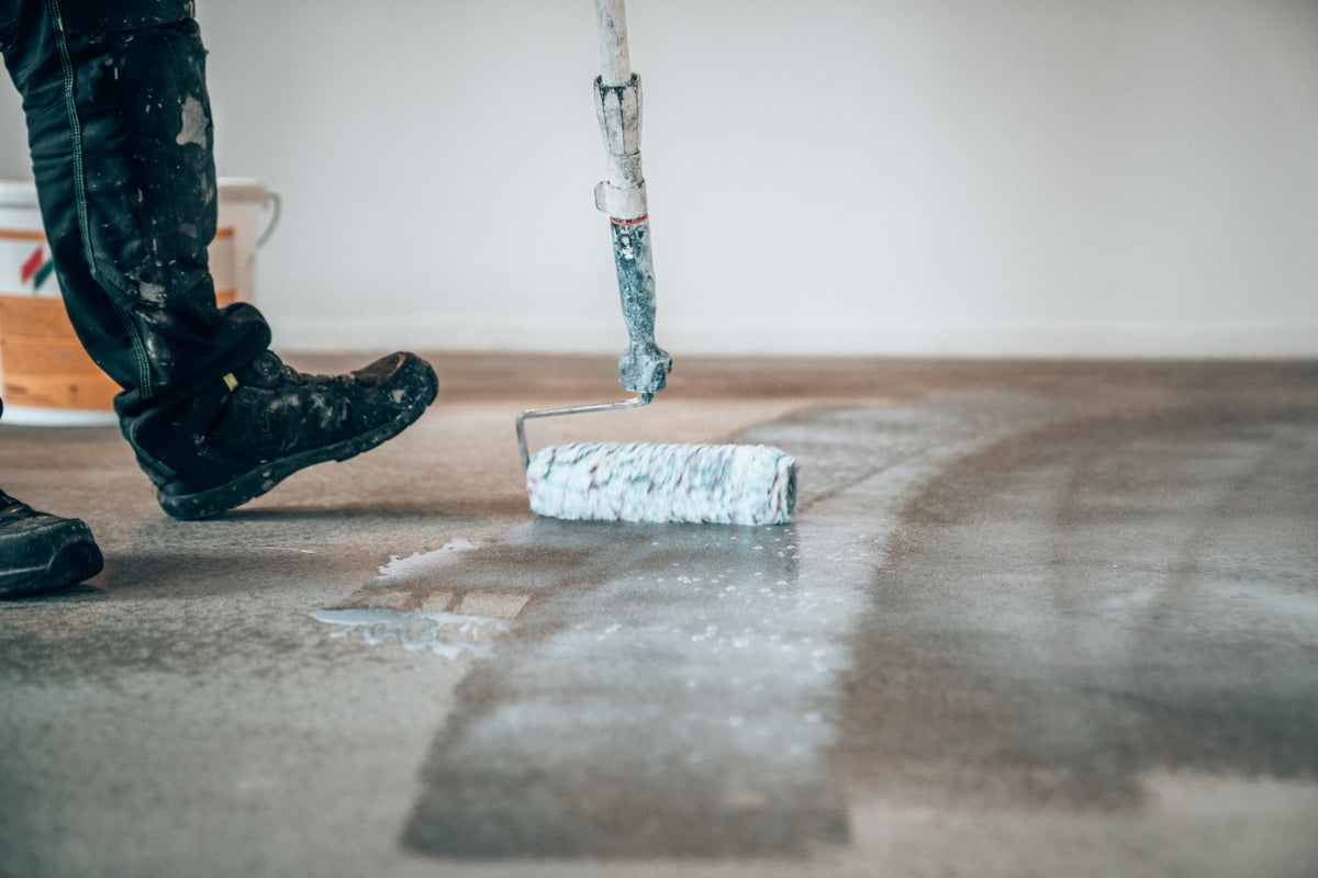 Hydrogrund being applied to the concrete floor with a roller