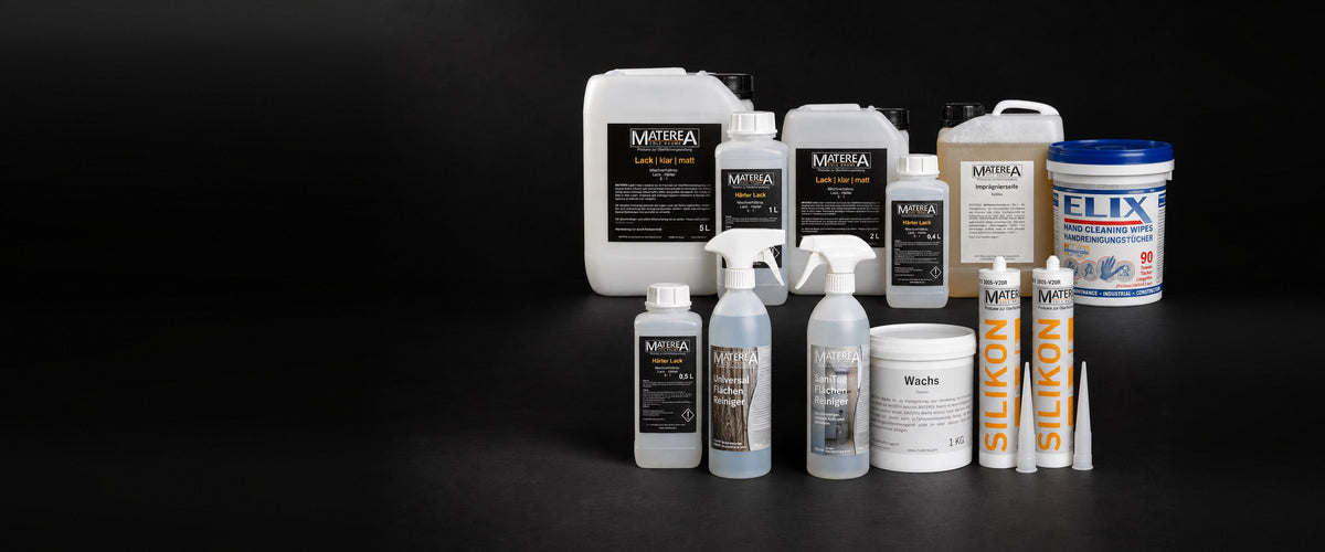 Varnish, hardener, impregnating soap, wax, cleaners and silicone as a group on a black studio background