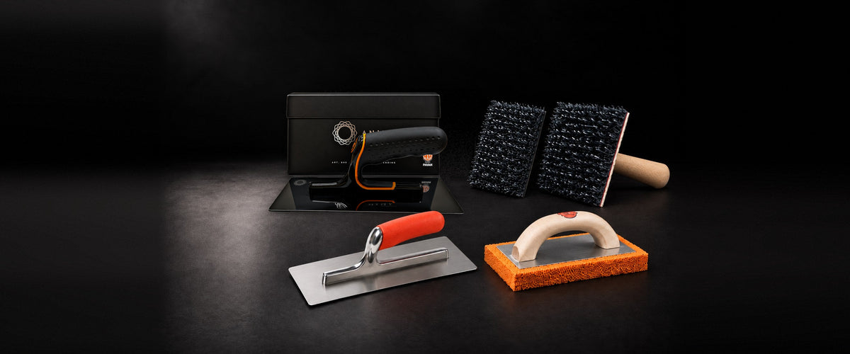 Trowels, pads and sponge float as a group on a black studio background